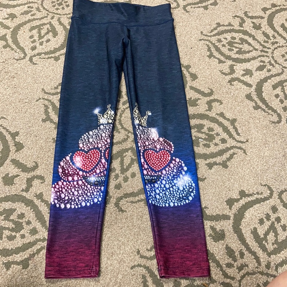 Justice leggings with “poop” emoji